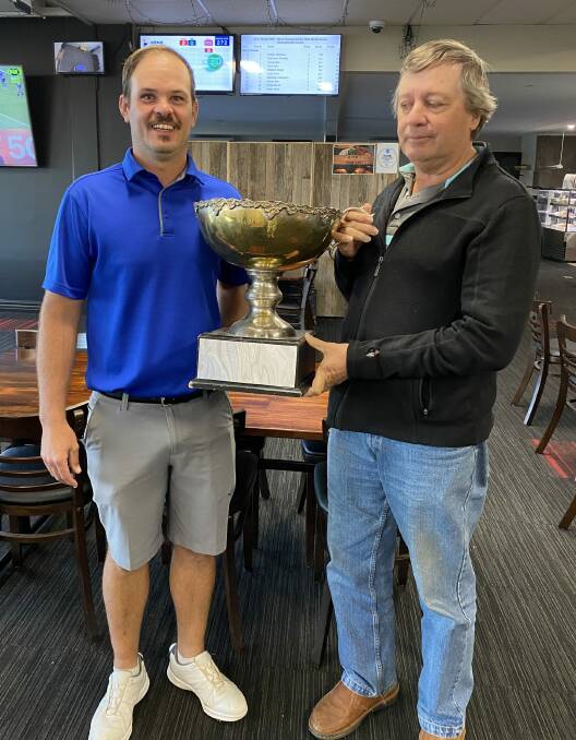 HELD HIS LEAD: Steve McDonald is presented the champion's trophy by John Perfect after winning by four strokes. Photo: BATHURST GOLF CLUB