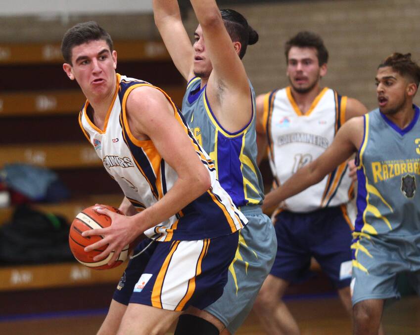 DEFEATED: Bathurst Goldminer Matt Gray, pictured in his side's win against Liverpool-Macarthur Razorbacks earlier this season, found 26 points in Saturday's loss. Cade Flores, guarding Gray, scored 28 points. Photo: PHIL BLATCH