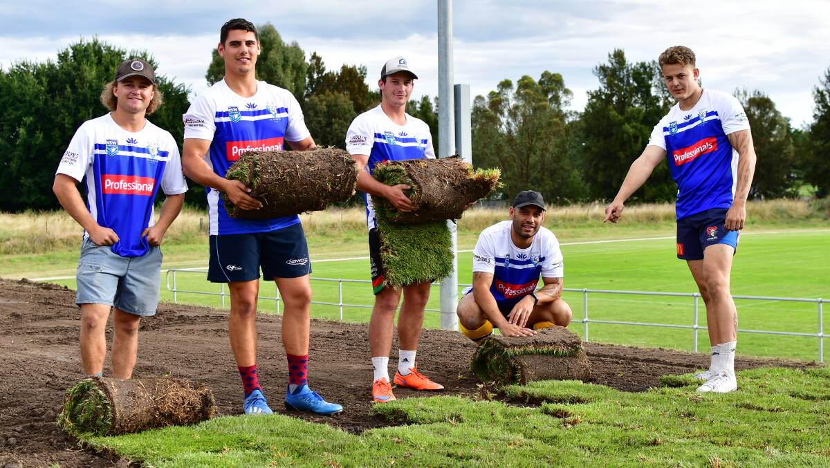 IT'S TURF TIME: St Pat's players Cooper Noonan, Aaron Mawhinney, Mick Clarke, Tyson Medlyn and Cooper Ackroyd get stuck into some turf laying on Thursday afternoon at Jack Arrow Oval. Photo: ALEXANDER GRANT