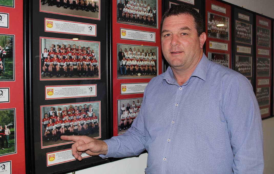 CALLING TIME: Panthers Bathurst general manager John Fearnley, with his 1997 team photo for the Bathurst Penguins. Photo: BRADLEY JURD