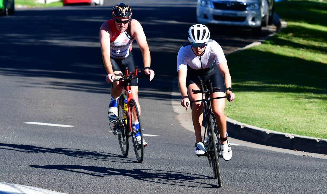 RIGHT NEXT TO EACH OTHER: Hollee Simons leads Tom Hanrahan on the end of the bike leg in Sunday's Bathurst Wallabies Triathlon Club opening round race. The pair spent the entire event within sight of each other. Photo: ALEXANDER GRANT