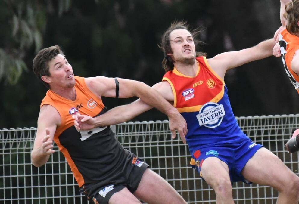 TUSSLE: Bathurst Giants' Lenny Hayes gets tangled up with Dubbo Demons' Tom Barber during last Saturday's game. Photo: CHRIS SEABROOK