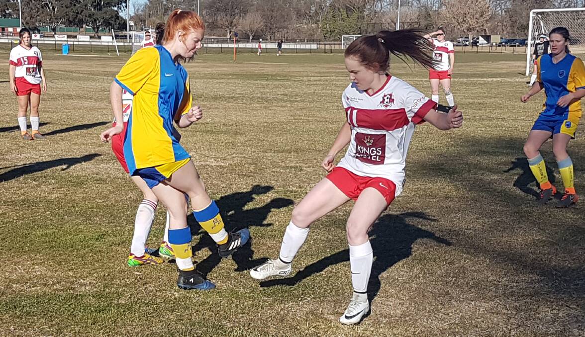 TOP OF THE TABLE GAME: Eglinton's Katie Kennedy and CSU's Tegan Kerr in action during Sunday's Bathurst District Football Ladies Premier League game. Photo: ALEXANDER GRANT