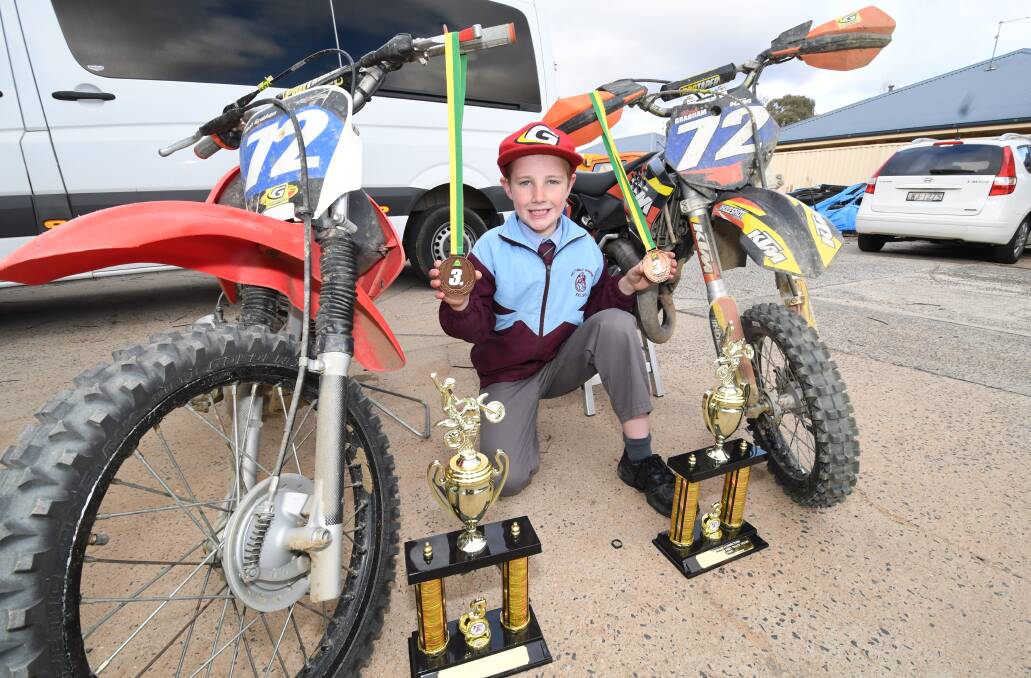 PODIUM RESULTS: Noah Grabham between his four and two-stroke bikes he used to pick up a pair of third placings with at the recent Australian Junior Dirt Track Championships Showdown. Photo: CHRIS SEABROOK
