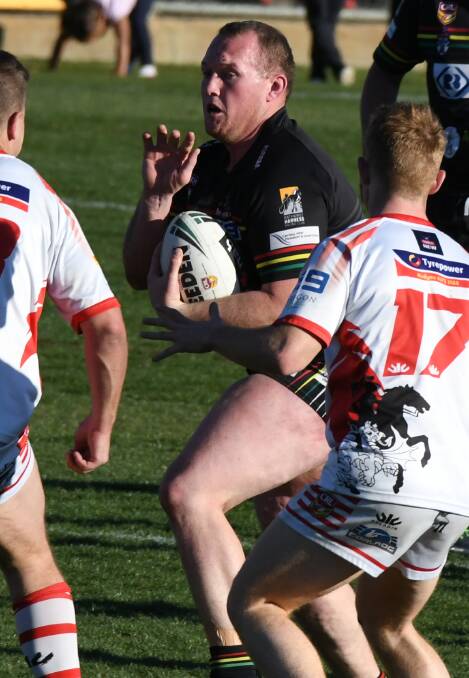 LEADING THE CHARGE: Brent Seager makes a run at the Mudgee Dragons defensive line during Sunday's grand final. Photo: CHRIS SEABROOK