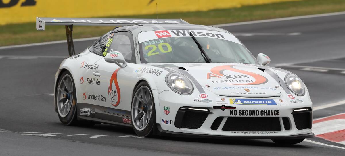 WET: Adrian Flack turns into Pit Straight during the Carrera Cup practice session on Thursday. Drivers were tested in the wet conditions early in the session before the track began to dry out. Photo: PHIL BLATCH