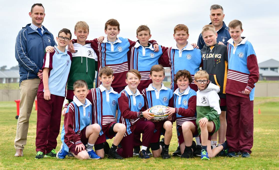 ON TO THE NEXT STAGE: Coaches Dane Fitzpatrick and Brent Dennis with their Holy Family School rugby side. Photo: ALEXANDER GRANT