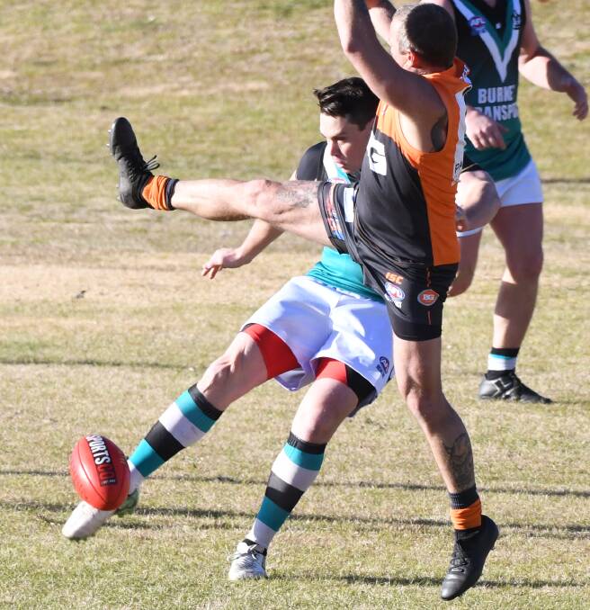 BIG BOOT: Adam Ryan launches a ball out of the centre during last round's meeting with Bathurst Giants. The Bushrangers Outlaws have another tough encounter this week when they play Orange Tigers. Photo: CHRIS SEABROOK
