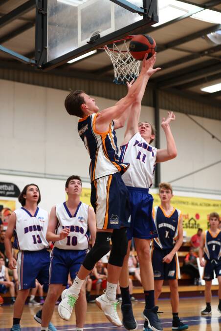 RISING UP: Bathurst Goldminers Under 18s Blue's Jay Cole goes up for a shot against Dubbo Rams Blue on Sunday. Photo: PHIL BLATCH