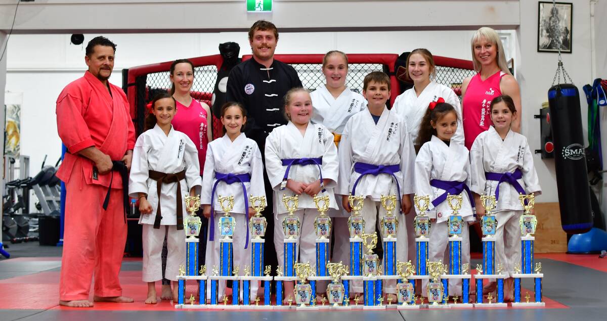 COLLECTION: Pollets Martial Arts teachers and students display their collection of trophies from their recent outing to the ISKA Australian Open held at Liverpool. Photo: ALEXANDER GRANT