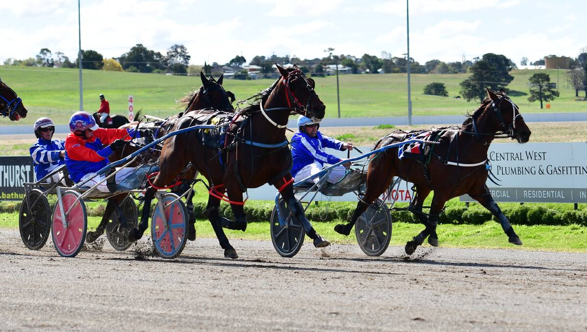 SLIDING ON BY: Rockslide (left) works past Wiggle Wiggle Woo to win the third event on the card at Bathurst Paceway on Sunday. Photo: ALEXANDER GRANT