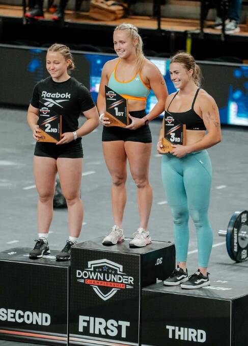 Roxy George stands in the middle of podium alongside Chloe Saliba and Maddy McArthur. Picture by CrossFit 2795.