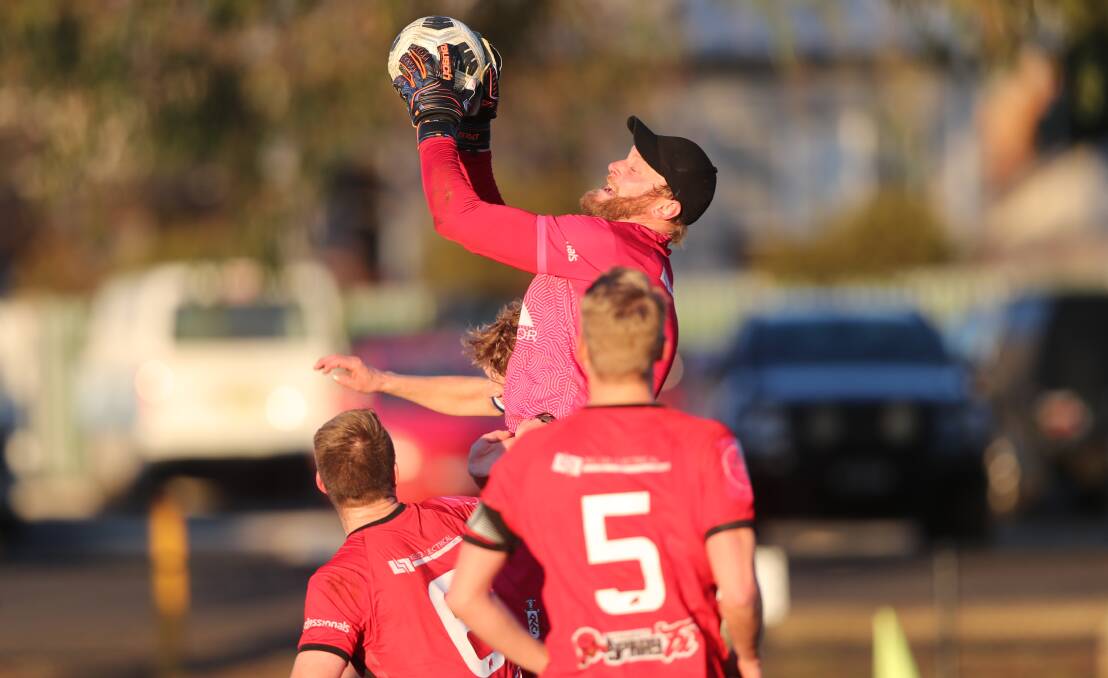 RISING: Panorama FC's Chris Davis goes up for a save in last round's Bathurst derby. Photo: PHIL BLATCH