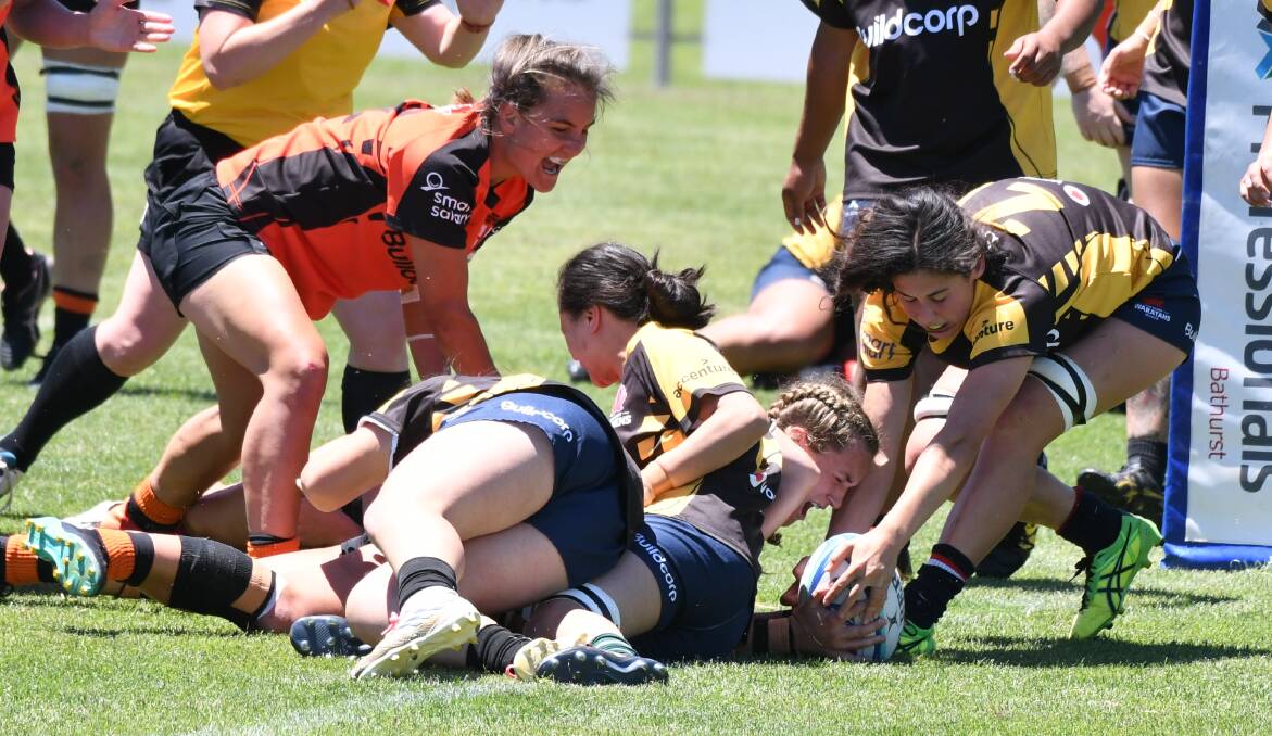 REACHING OUT: Country's Arabella McKenzie screams in delight as she dives over for a try against Sydney Gold. Photo: CHRIS SEABROOK