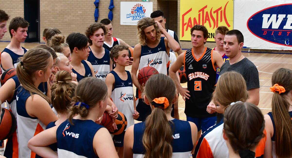 LISTEN UP: Curtis Sardi talks with players during the warm up of Sunday's coaching clinic he ran at Bathurst Indoor Sports Stadium. Photo: ALEXANDER GRANT