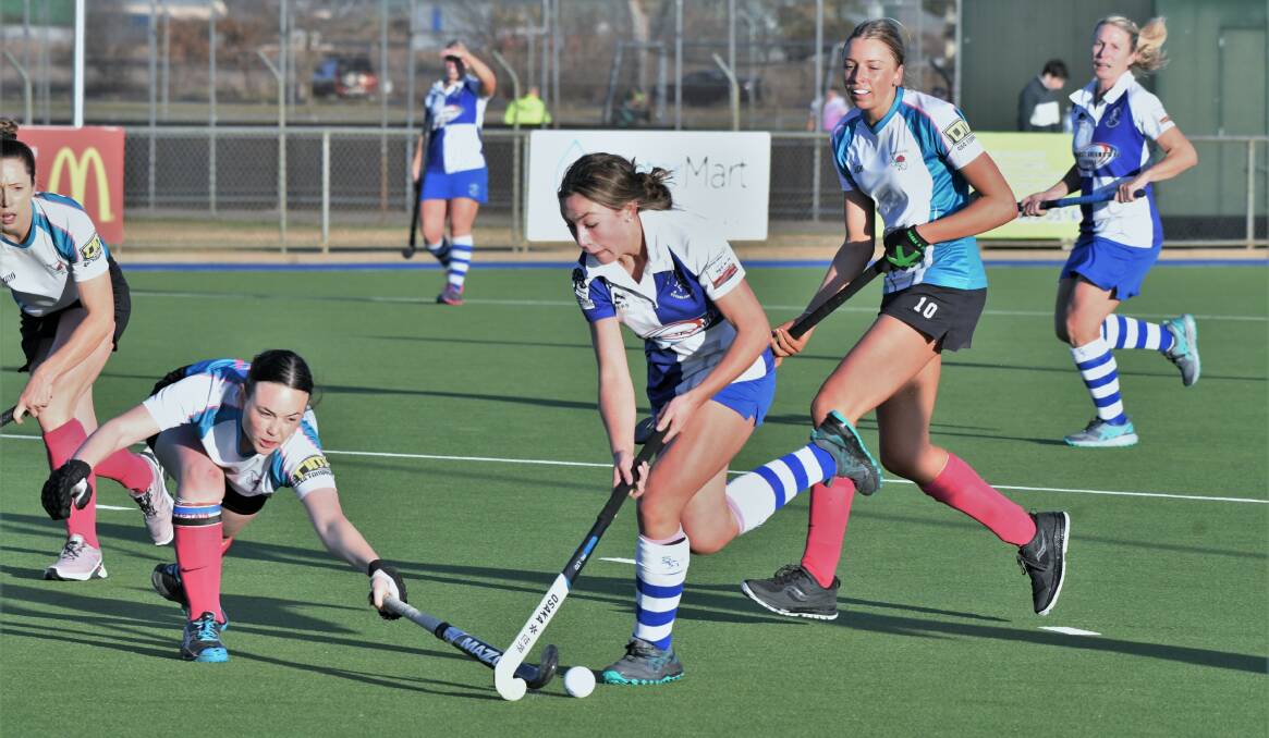 MOVING UP: Lily Kable tries to avoid a Erin Cobrcroft tackle in the Saints' 2-0 win over Bathurst City on Saturday. Photo: CHRIS SEABROOK