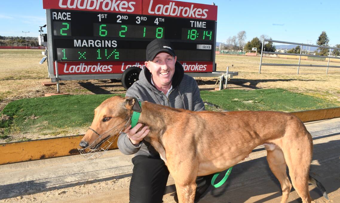 TOP JOB: Winning trainer Mark Wicks with Grizzly Adams. Wicks' greyhound was impressive in his first start in over three months. Photo: CHRIS SEABROOK