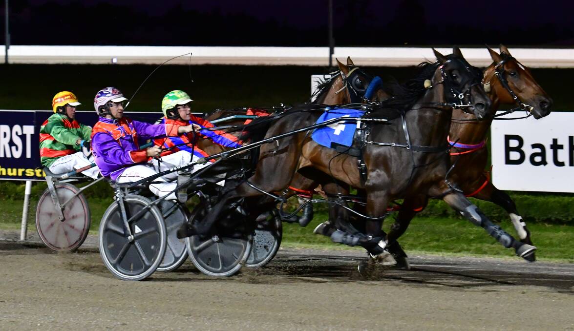GOT THERE IN THE END: Callmequeenbee (closest to camera) begins to move past Maximus Red in the closing stages of Wednesday's Gold Crown Carnival 18-28 March Pace (1,730 metres) at Bathurst Paceway. Photo: ALEXANDER GRANT