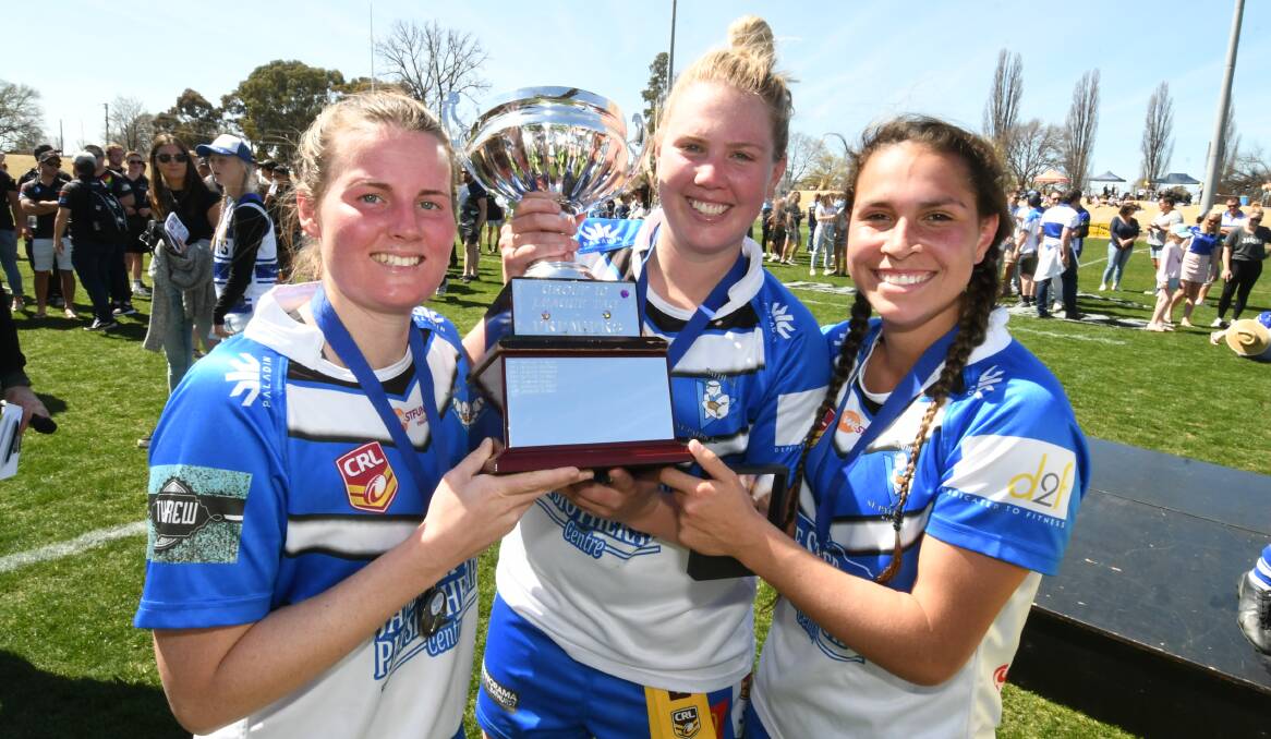 STARS: Double try scorer Bronte Emanuel, captain Mish Somers and best on ground Erin Naden lift the trophy. Photo: CHRIS SEABROOK