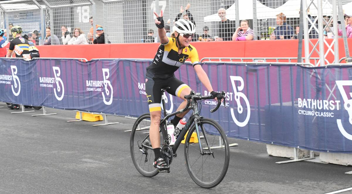 WINNER: Jodie Martin celebrates as she crosses the finish line. Photo: CHRIS SEABROOK