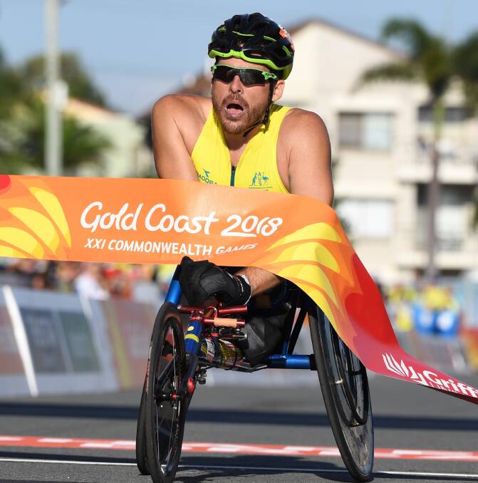 FITTING FINALE: Kurt Fearnley marked his final appearance in Australian colours by winning the inaugural Commonwealth Games men's T54 marathon. Photo: AAP, DEAN LEWINS