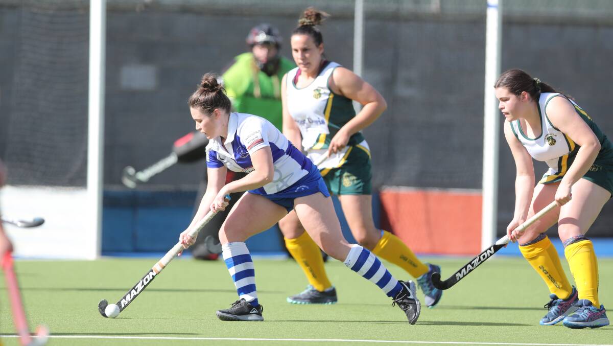 ENJOYING THE SEASON: Esther Hotham keeps the ball away from the Orange CYMS defence during last Saturday's semi-final. Photo: PHIL BLATCH