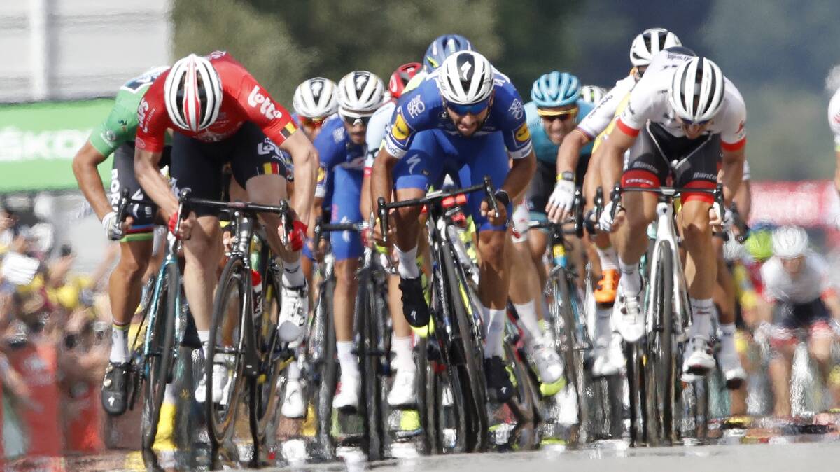 HERE HE COMES: Quickstep's Fernando Gaviria (centre) sprints to victory in stage four of the Tour De France. Photo: AP