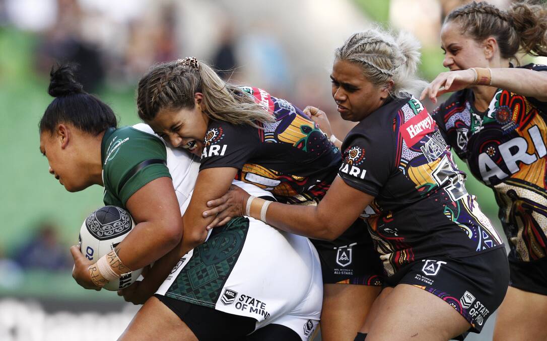 DEFENSIVE GAME: Indigenous All Stars' Kandy Kennedy (second from right) tackles a Maori opponent. Photo: AAP