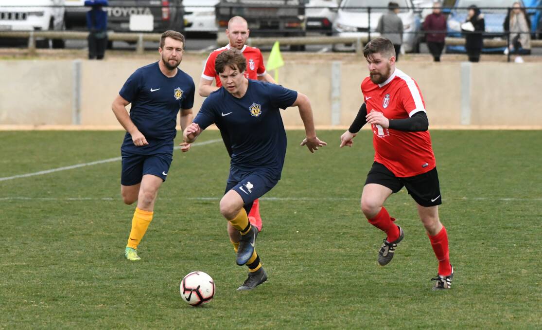 PACE: Abercrombie FC's James Baker brings the ball out of his half during Sunday's meeting against Panorama FC Black. Panorama fought back in the second half but a late AFC goal secured a 4-2 win. Photo: CHRIS SEABROOK