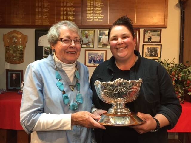 SILVERWARE: Western Disitricts Ladies Golf Association Counsellor Val Heferen presents Chelsea Litchfield with the Jubilee Cup and the Alan Yuille Championship Cup. Litchfield won the title by 13 strokes. Photo: CONTRIBUTED