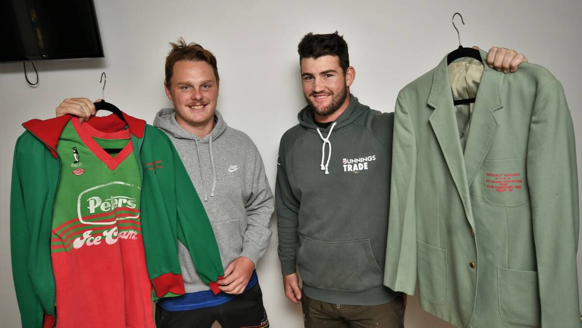HISTORY: Noah Griffiths and Mack Atkins, with Bathurst Railway memorabilia, will take to the field this Saturday in red and green. Photo: CHRIS SEABROOK