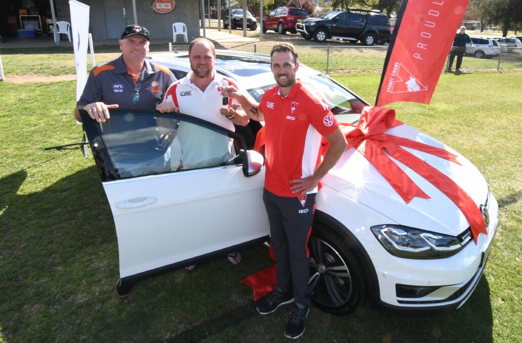 NEW CAR: Mark Kennedy, Scott Traves and former Sydney Swans player Nick Davis with the Volkswagen Golf Alltrack. Photo: CHRIS SEABROOK