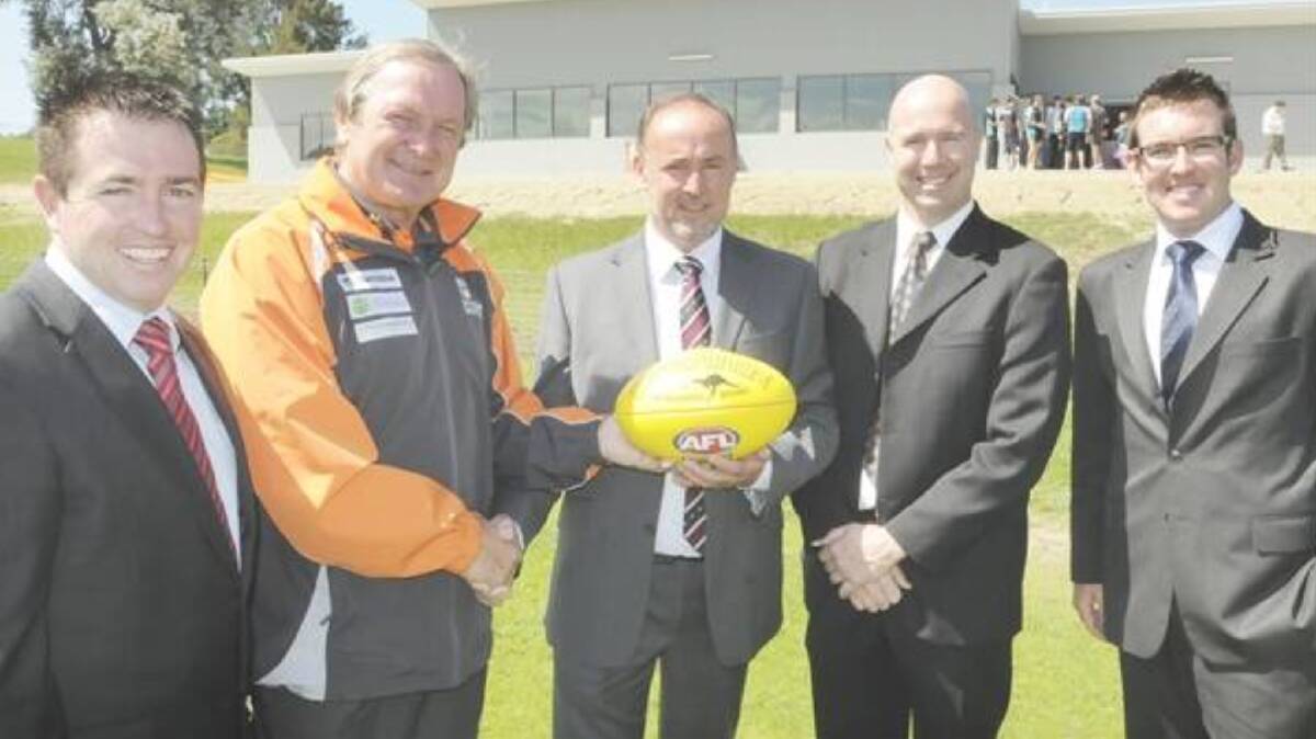 Grundy (Centre) during the opening of the Bushrangers' clubhouse in 2012, shaking hands with AFL legend Kevin Sheedy.