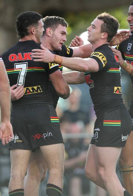 GREAY DAY OUT: Liam Martin celebrates with Panthers teammates following his try. Photo: PHIL BLATCH