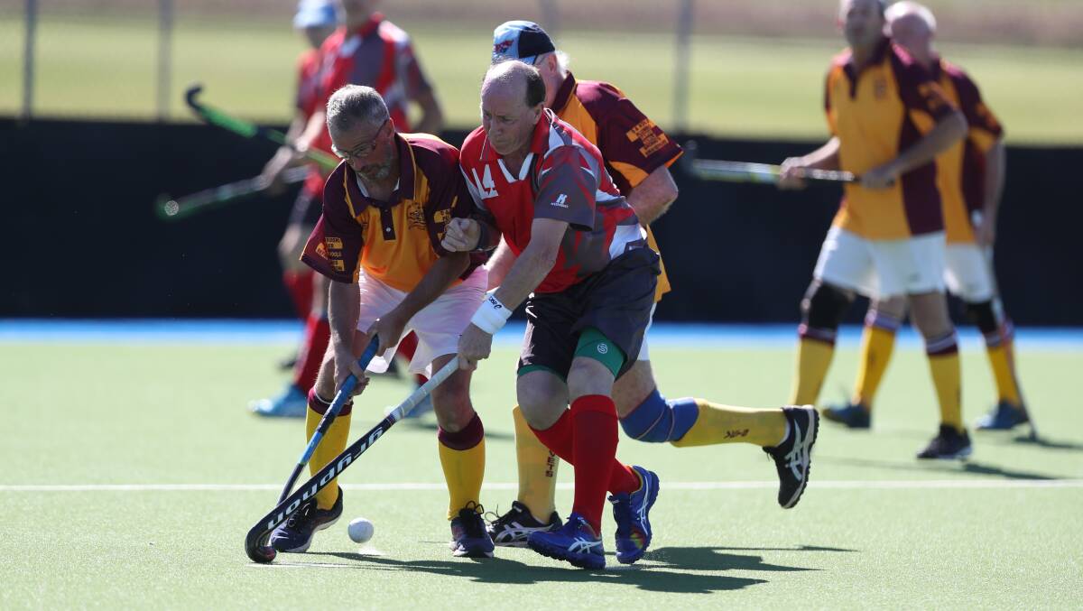 FINISHING ON A HIGH: Bathurst 2's Alan McGrath battles with Manning Valley's Peter Cubbin during their game on Sunday. Bathurst won a close contest 2-1. Photo: PHIL BLATCH