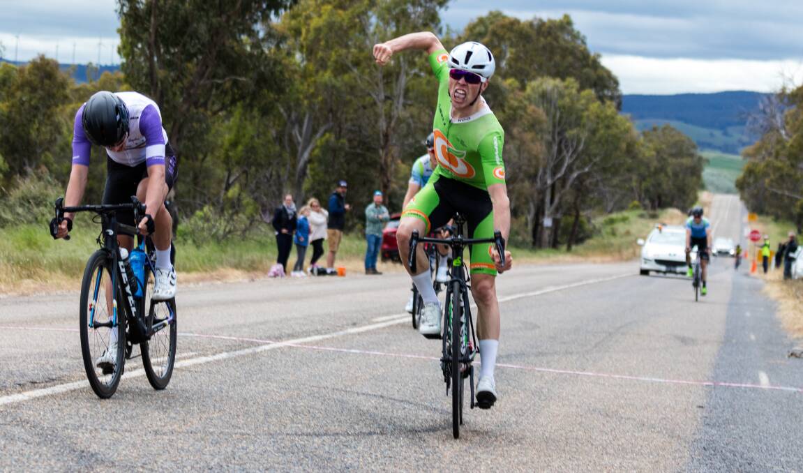 YOU BEAUTY: Will Hodges throws his arm up in celebration after winning the NSW Men's Elite Road Road title. Photo: RYAN MIU