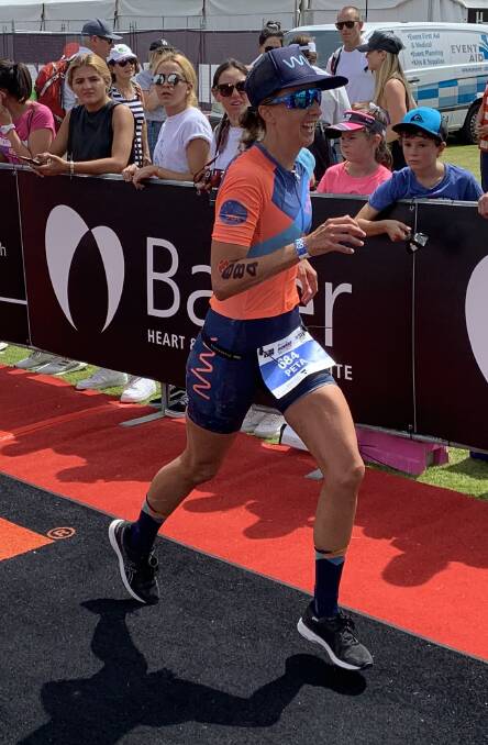 FIRST HOME: Bathurst triathlete Peta Cutler approaches the finish line during Sunday's Ironman 70.3 Geelong. Photo: CONTRIBUTED