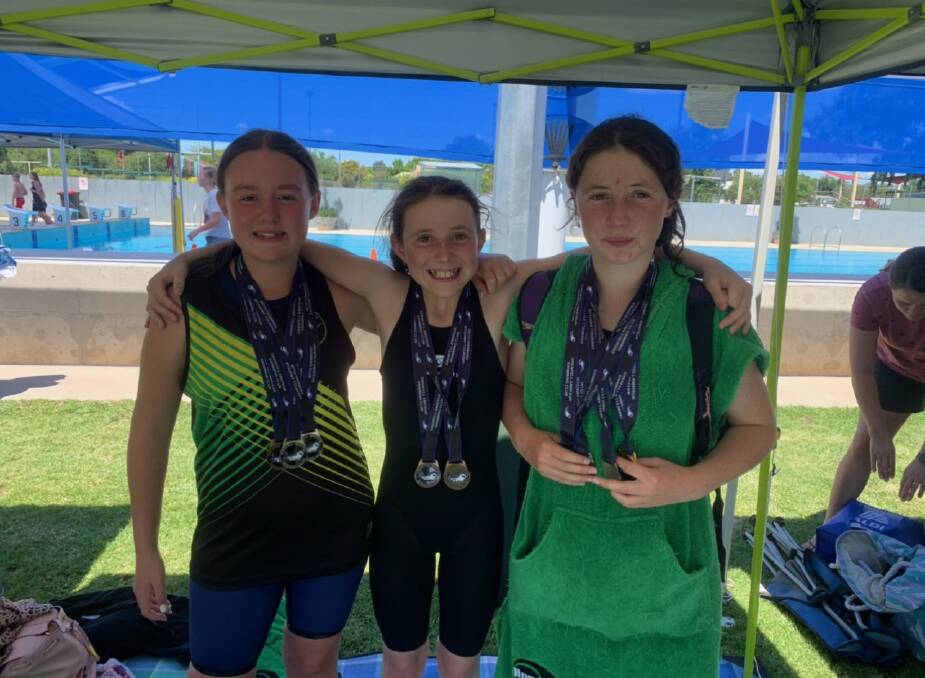 HAPPY TRIO: Bathurst Swim Club's Emily Saint, Hadlie Henson and Violet Henson enjoyed the weekend's racing at the Grenfell Swim Carnival. Photo: CONTRIBUTED
