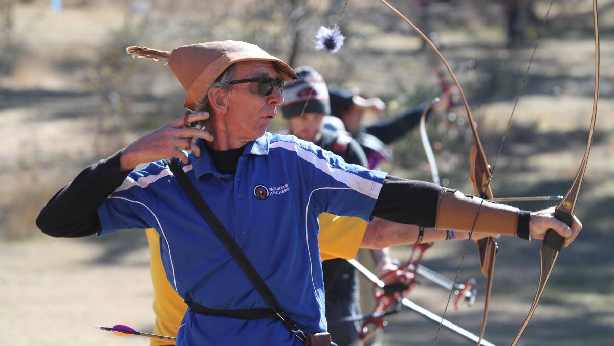 LET FLY: Andy Betts watches the flight of his arrow during the Bathurst Archery Festival. Photo: PHIL BLATCH