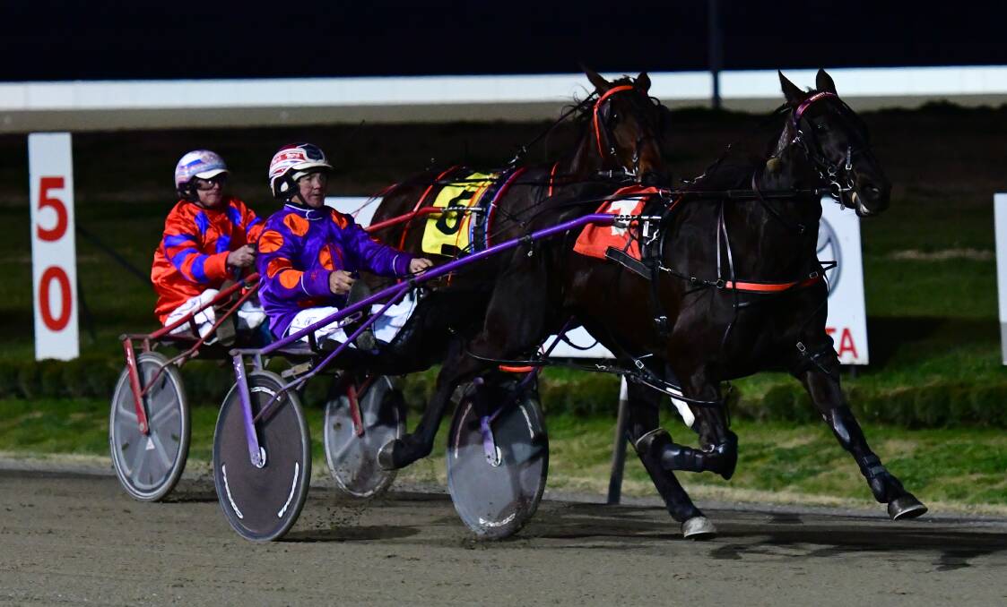 BACK ON TOP: Voodoo Lou leads home Akuma in Sunday evening's Reliance Bank Pace (1,730 metres) at Bathurst Paceway. It's the second career win for the filly in her fifth start. Photo: ALEXANDER GRANT