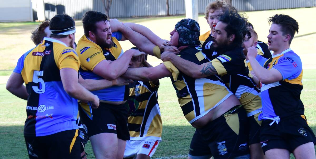 SWINGING: CSU and Dubbo Rhinos players get involved in an all-in brawl during Saturday's game at Apex Oval. Five players were shown red cards across the course of the match - four from this fight. Photos: AMY McINTYRE