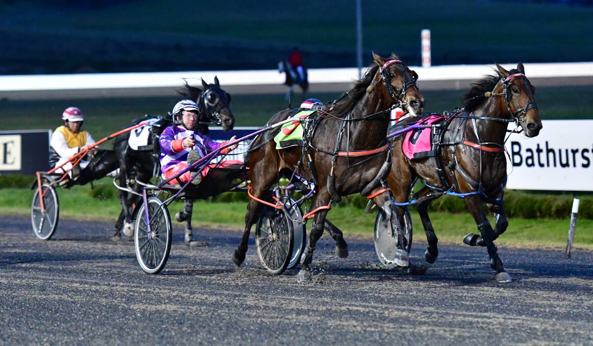 GOTCHA: Jason Hewitt and Infinity Beach (centre) manages to chase down Always Thunder in the first event of Wednesday night's Bathurst Paceway meeting, giving trainer Bernie Hewitt the 1-2. Photo: ALEXANDER GRANT