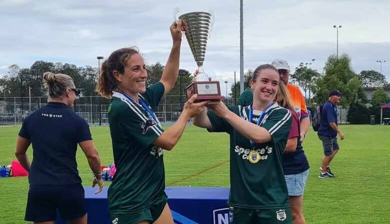 Bec Smyth and Sarah Colman hold the trophy aloft following Western Rams' grand final win. Picture supplied.