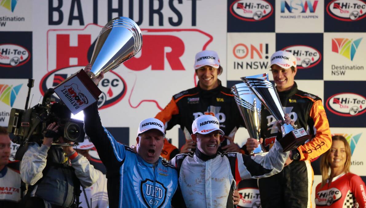 THAT WINNING FEELING: Paul Morris and Luke Searle (foreground) celebrate their Bathurst 6 Hour victory on Sunday while runners-up, and last year's champions, Chaz Mostert and Nathan Morcom watch on. Photo: PHIL BLATCH