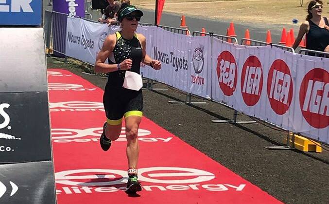 MADE IT: Bathurst's Kristy Powyer crosses the finish line in the Callala Triathlon to win age group bronze.