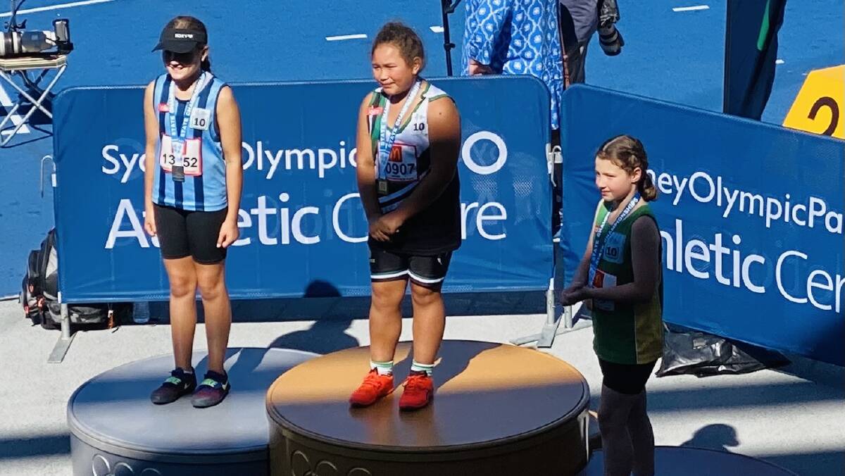 GOLDEN GIRL: Savannah Auvaa stands on the top step of the girls under 10s shot put podium at Sydney Olympic Park. Photo: CONTRIBUTED