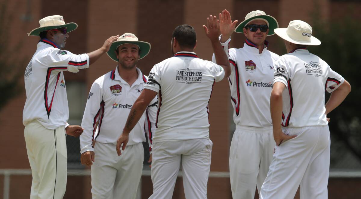 HIGH FIVES: Bathurst City celebrates after claiming a wicket last Saturday. Photo: PHIL BLATCH
