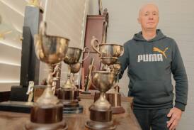 John Bullock with some of his family's sporting trophies. Picture by James Arrow.