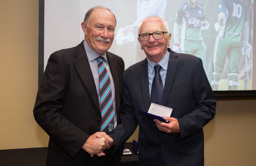 SIX IN A ROW: Graeme Glazebrook (right) receiving the Kevin Pye Medal from Cricket NSW Umpires and Scorers Association Life Member and Country Umpire Coach Neil Findlay. Photo: TROY PENMAN
