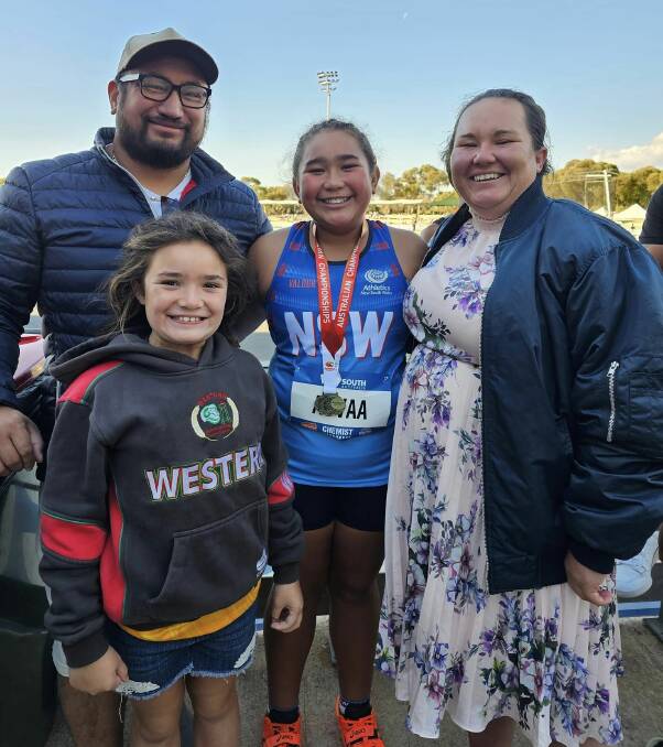 Savannah with her family after the gold medal presentation. Picture by Bathurst Athletics Club.